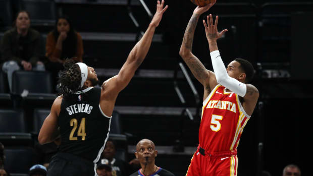Mar 8, 2024; Memphis, Tennessee, USA; Atlanta Hawks guard Dejounte Murray (5) shoots as Memphis Grizzlies forward Lamar Stevens (24) defends during the second half at FedExForum. Mandatory Credit: Petre Thomas-USA TODAY Sports